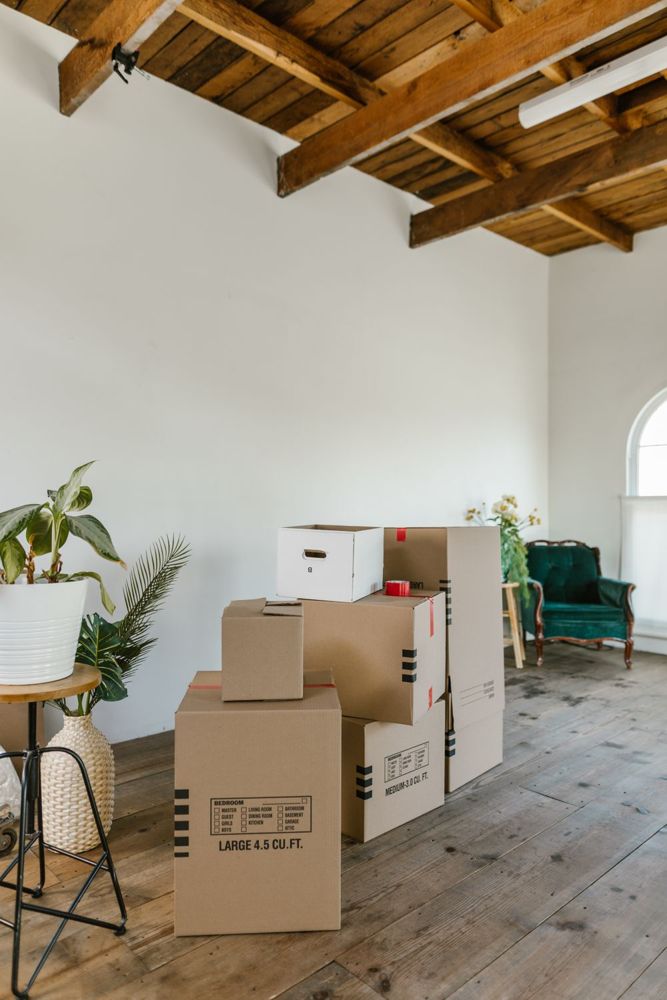 Empty apartment room with cardboard boxes after moving out